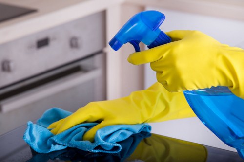 Person blotting a fresh spill on fabric for stain removal